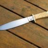 Camp knife handle ground to shape.