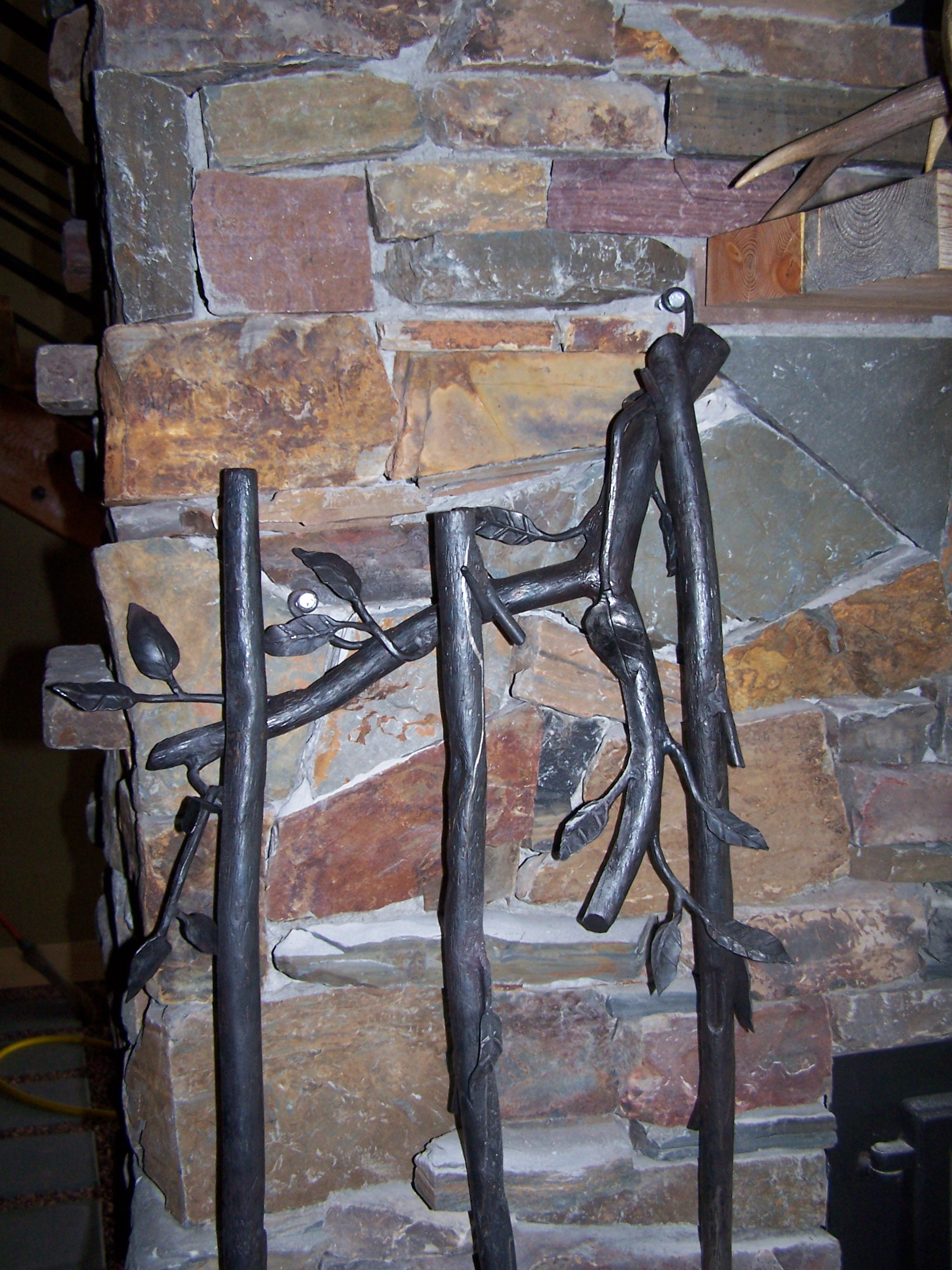 Close up of fireplace tools hanger attached to fireplace.