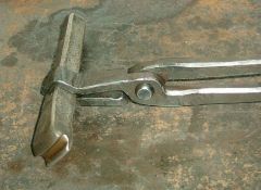 Grooving tool with tongs designed to hold them.