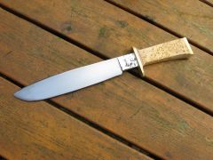 Camp knife handle ground to shape.