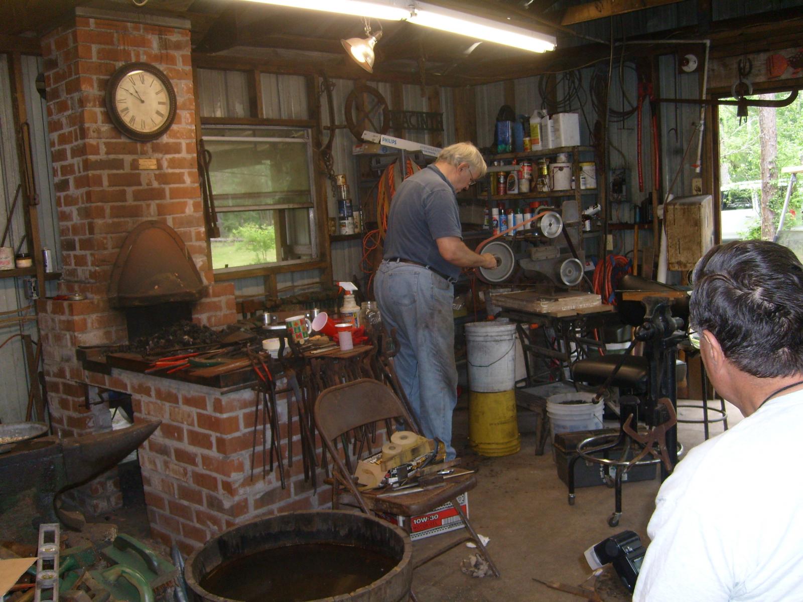 Dr. Jim Batson grinding a blade at the Gulf Coast Blacksmith's conference  