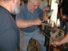 Dr. Jim Batson draw fileing a blade at the Gulf Coast Blacksmith's convntio
