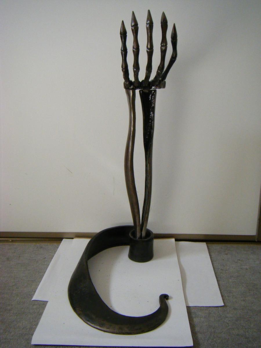 Skeletal fore arm ash tray stand