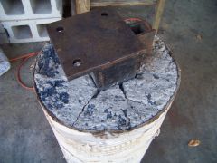 Chunk of metal sunk in concrete