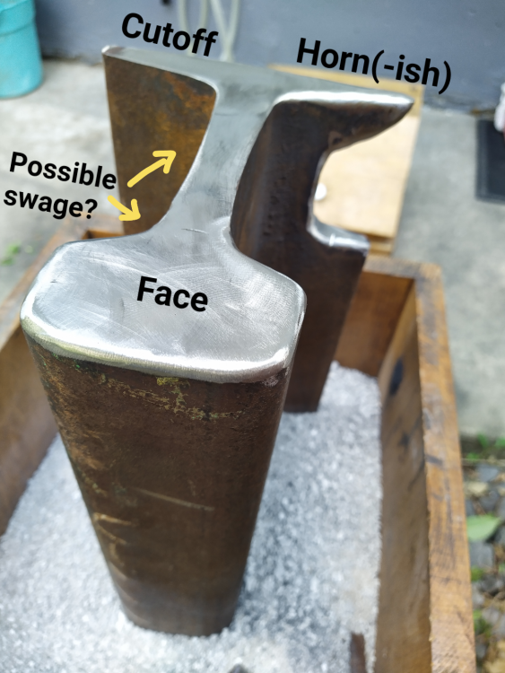 Railroad rail anvil positioned on end with shaping to form horn out of original base ledge